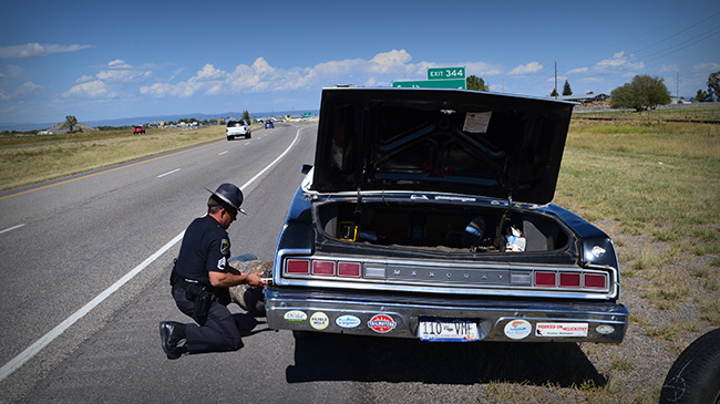 Cop helps replace Clyde's tire on the way to Bozeman, Montana.