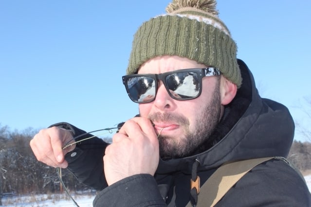 Ben Deices his flyrod - winter trout fishing