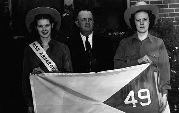 Political agitator A. R. Swickard (center), flanked by miss Absaroka, Dorothy Fellows, and her attendant, Esther Aspaas.